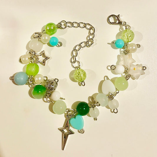 Green Beaded Cluster Charm Bracelet with colorful beads and charms on a light background
