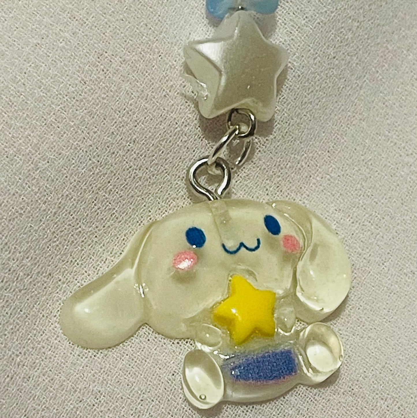 Sanrio phone charm ( cinnamoroll ) with beads and (star) charms attached  